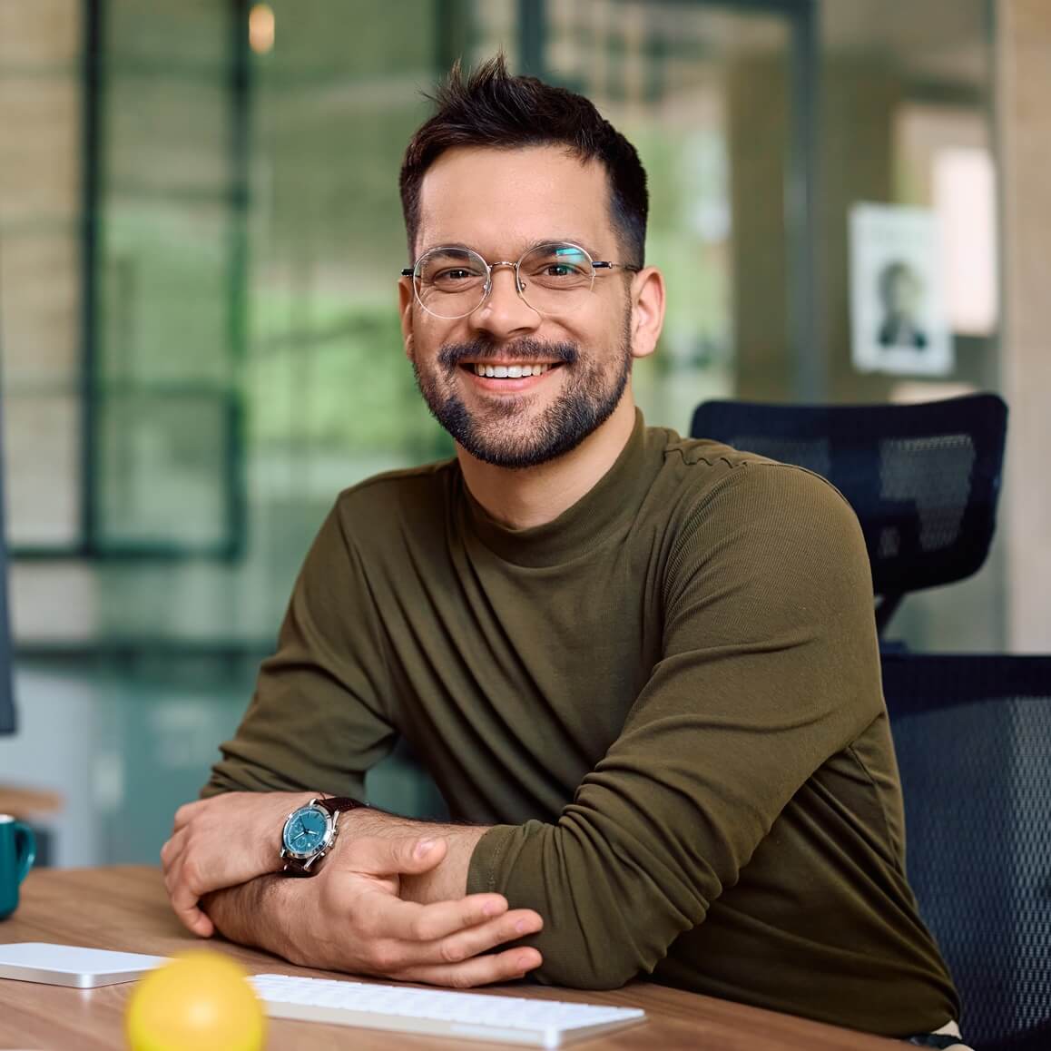 happy male entrepreneur at his office desk lookin vc5mdxr.jpg